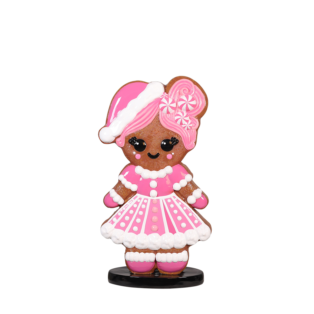 Pink Girl gingerbread character with pink icing dress and candy bow